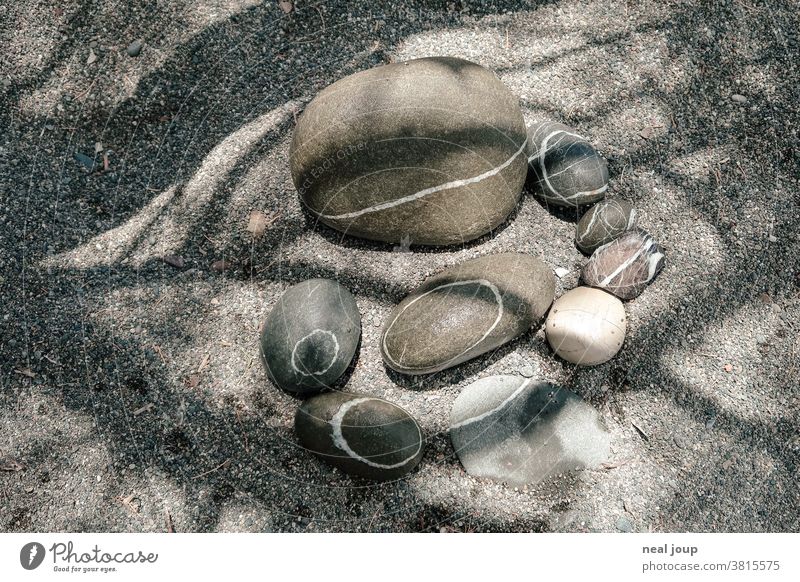 Large pebbles with white rings in the sand stones Nature Pebble tranquillity harmony Relaxation Pattern circles Abstract lines Moody vacation Beach Sand