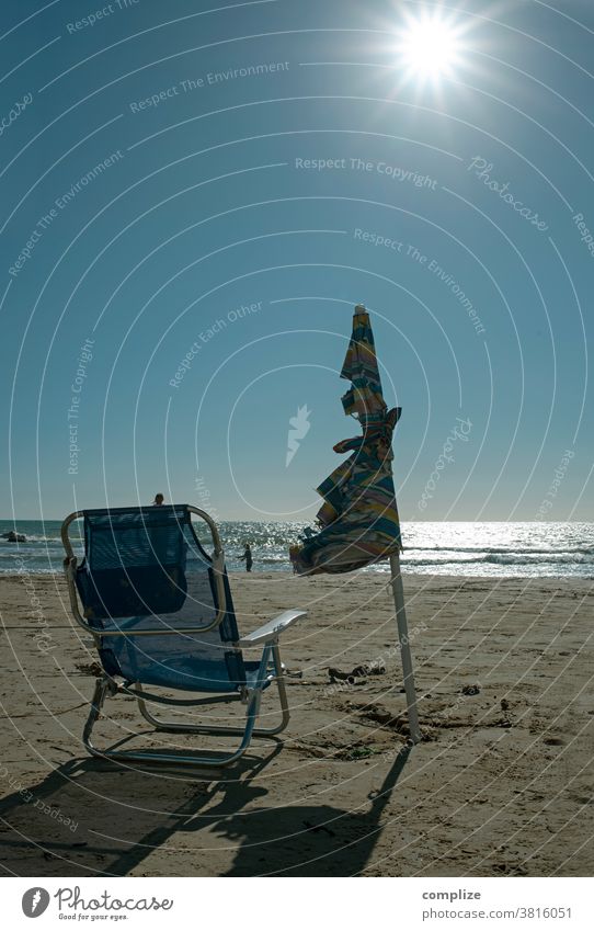 Holidays 2020 vacation Beach by oneself Broken Sunshade sun lounger Camping Camping chair torn Sandy beach Ocean slanting trash Sicily Italy