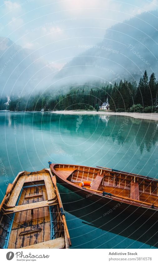 Wooden boat on clear lake in mountains turquoise water crystal vessel highland majestic wooden tranquil float calm scenic landscape nature idyllic peaceful pond