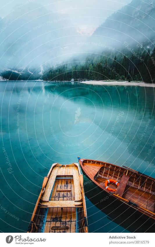 Wooden boat on clear lake in mountains turquoise water crystal vessel highland majestic wooden tranquil float calm scenic landscape nature idyllic peaceful pond
