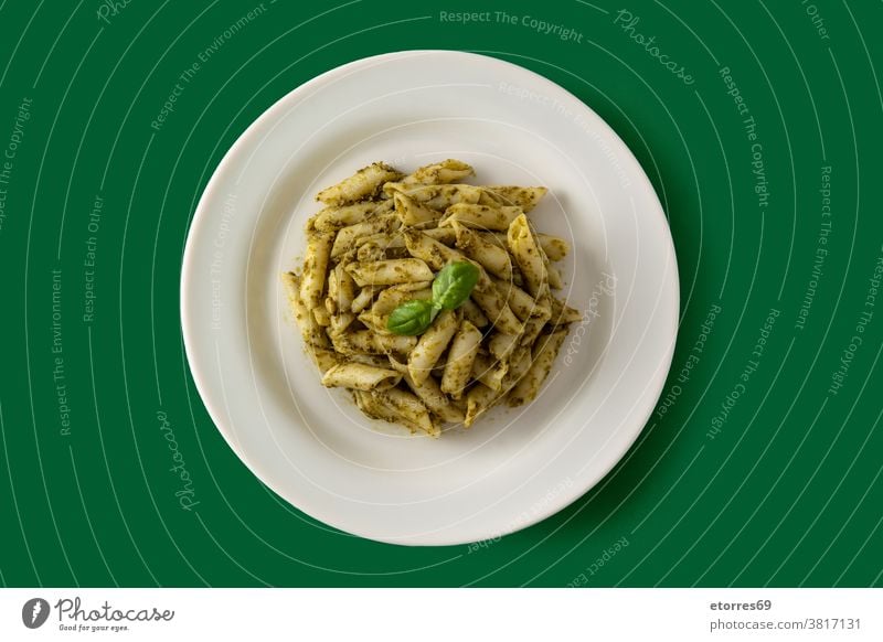 Penne pasta with pesto sauce basil cooked cuisine dish food gourmet green isolated italian macaroni penne plate recipe served white