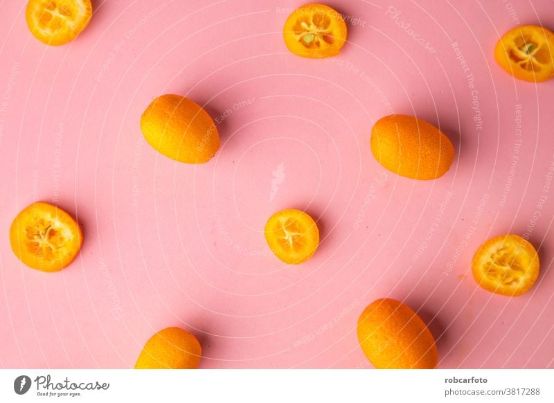 kumquat orange fruit on pink background fresh tropical citrus food fortunella organic ripe yellow color vegetarian cumquat healthy oval nature green mandarin