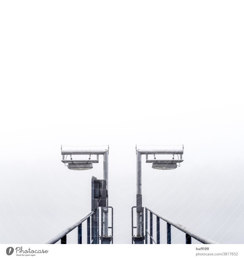 Landing stage in the fog Jetty Fog Bad weather Lamp Footbridge rail Weather Winter Autumn Harbour Loneliness Fatigue Silver Stagnating Calm Shroud of fog