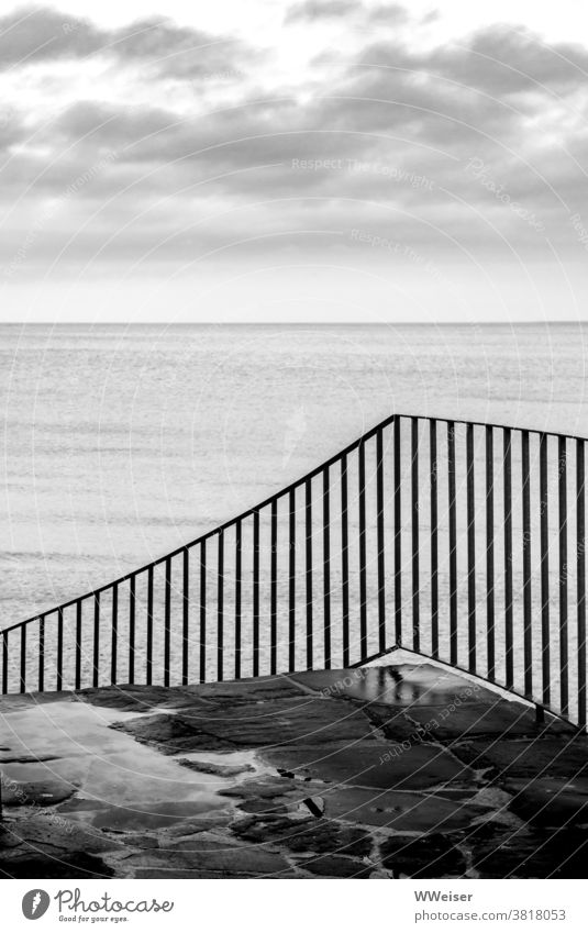 The wet stairs lead down to the beach Ocean Beach rail stagger Stone Wet Stairs Water Clouds Sky Rain Damp Deserted coast Baltic Sea Gray Dreary melancholically