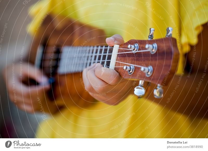 Close up of girl with ukulele artist differential focus fingers hands instrument lifestyle melody music musical musician one outdoors person play playing sing