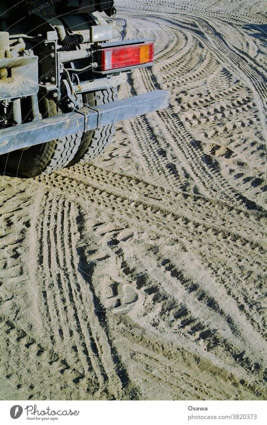 Truck and tire tracks on a construction site lorry Stern Rear light Rear side Tire Skid marks Prints Bumper Sand Ground Earth Construction site earthworks