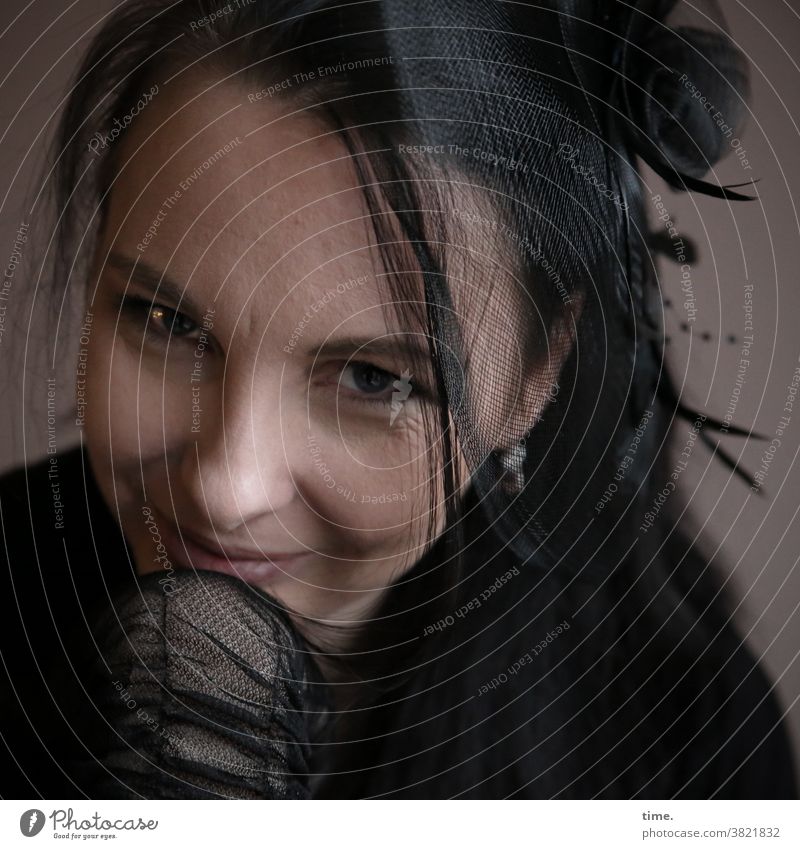 amused woman with hair net and gloves in semi-darkness Dark Net Gloves Watchfulness Feminine Looking Observe Black-haired Long-haired Respect Mysterious