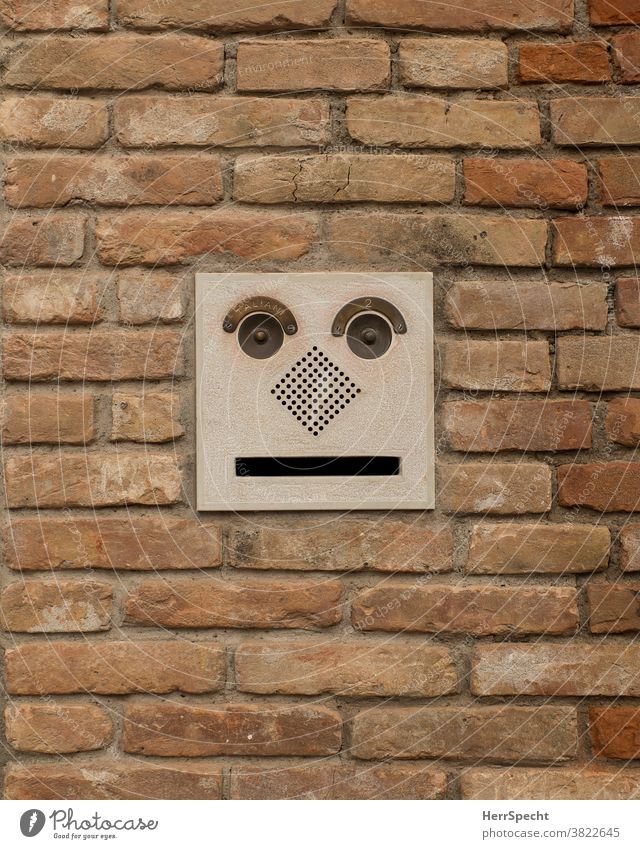 Mailbox with face Mailbox slot Brick wall Face grimace Funny Exterior shot Central perspective Wall (barrier) Copy Space bottom Town Subdued colour