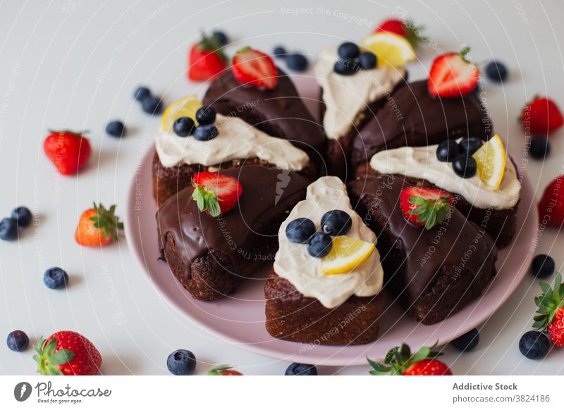Chocolate cake with berries and lemon chocolate berry piece homemade dessert sweet pastry baked cream delectable blueberry strawberry topping cut food yummy