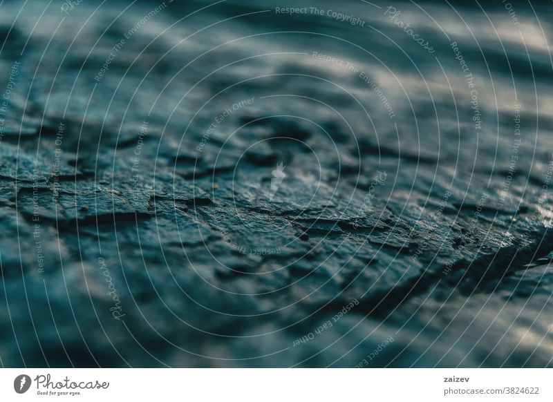 Macro of gray stone floor texture surface abstract cracked smooth hard tough area ground shapes pattern unfocused background detail macro art dark consistent