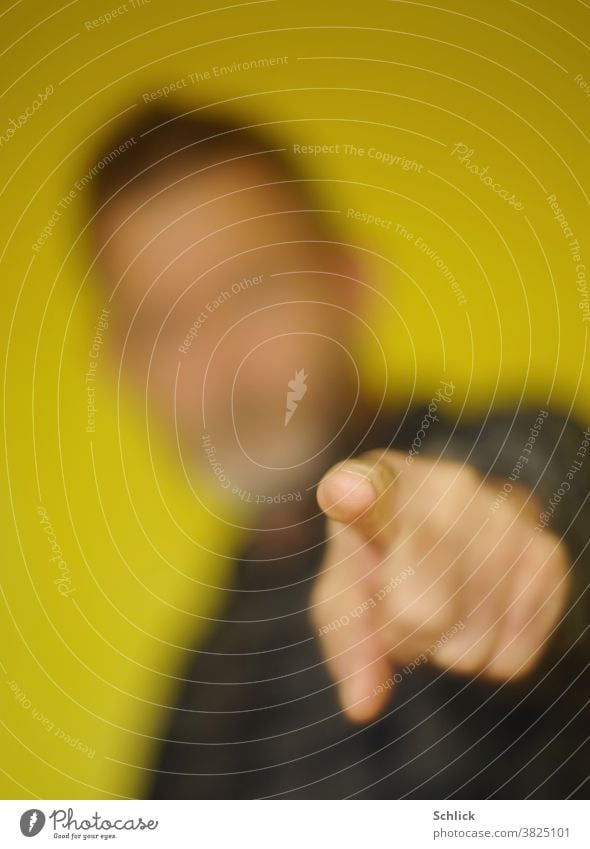 You there, man pointing your index finger at somebody Indicate Forefinger Man blurred shallow depth of field Fingertip portrait Yellow yellow background Teacher
