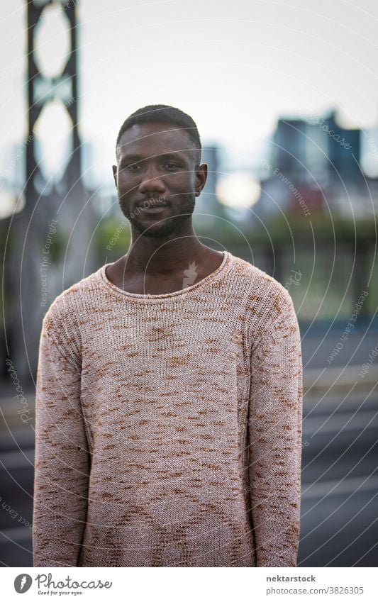 Handsome Black Man in Sweater Outdoors portrait man black pose African ethnicity looking away sweater fashion front view one person one man only 20-30 years old
