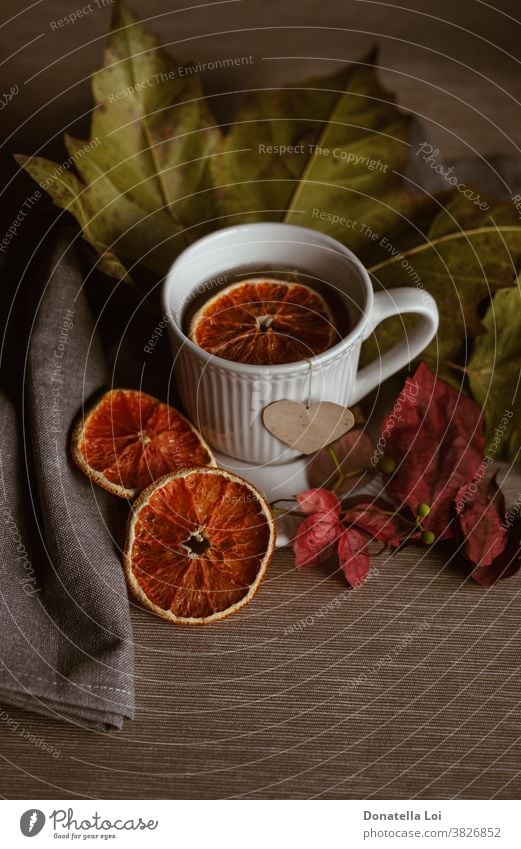 Cup of tea still life autumn colors cup drink dry fall food fruits heart indoor leaves light liquid moment morning orange porcelain studio shot warm white
