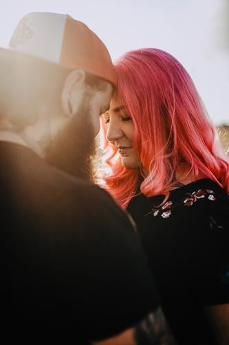 young couple with tattoos and pink hair teen Couple Love In love hug Sunset out Field Tattoo heartfelt Cuddling Hip & trendy Hipster Man Woman Sunbeam Sunlight