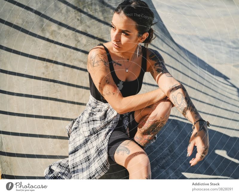 Stylish woman in skate park in summer style millennial street style trendy independent tattoo eccentric rebel female individuality weekend urban relax hipster