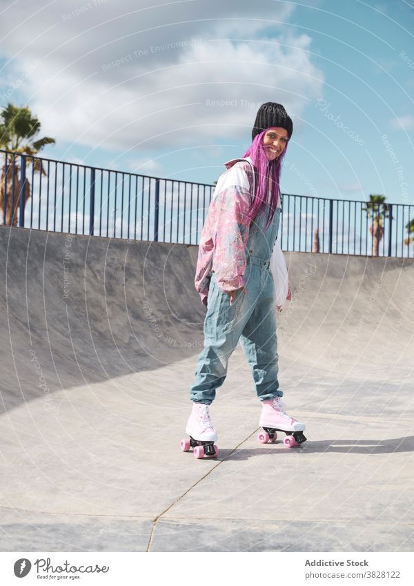 Stylish woman with pink hair in roller skates skate park hipster street style informal eccentric appearance female hobby having fun outfit trendy urban city