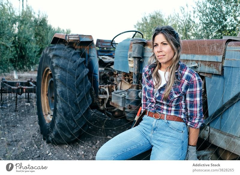 Female farmer with tractor on olive plantation harvest machine woman agriculture rural female satisfied adult small business owner work organic job agronomy