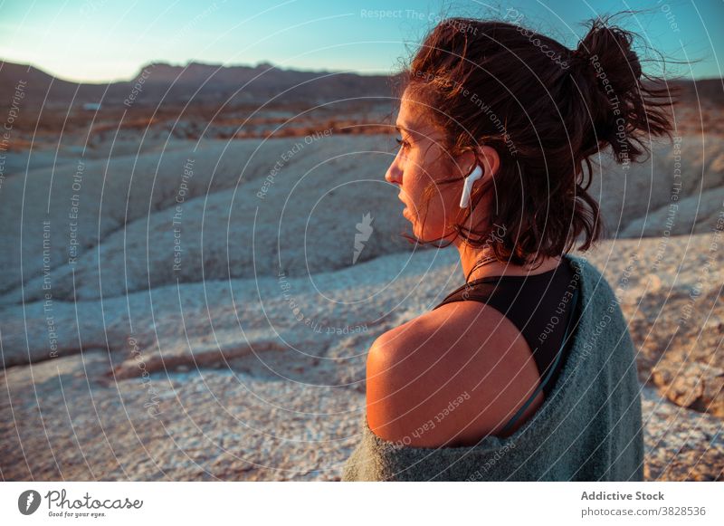 Woman enjoying sunset in desert valley woman badlands sporty peaceful contemplate relax tranquil nature female rough serene evening harmony rock sundown freedom