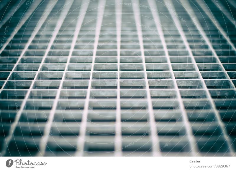 Closeup of an aged gray metal grid grate pattern detail metallic texture closeup steel iron structure abstract backdrop background geometric material design