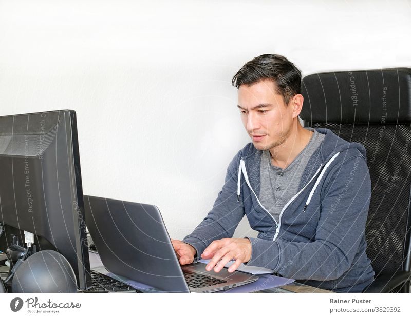 Man in casual outfit working from home with a laptop in the living room adult caucasian communication computer copy space entrepreneur freelancer home office