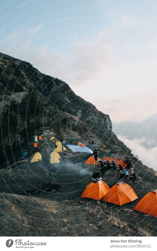 Base Camp - Rinjani Lombok camping Mountaineering Indonesia Clouds Orange Yellow Mystic take a break Volcano active Lava field Gray hikers group campfire