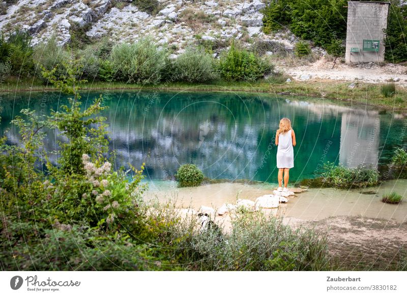 Woman in white dress at the turquoise-green karst spring Cetina in Croatia Pond White Dress Turquoise Green Stand reflection Nature nature park Reflection Lake