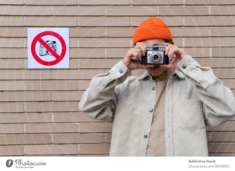 Man taking photos in restriction area man take photo violation break rule disobedience noncompliance rebel photography sign conformity device memory