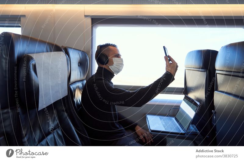 Busy man working in train during business trip entrepreneur businessman freelance smart laptop male passenger browsing smartphone internet online job transport