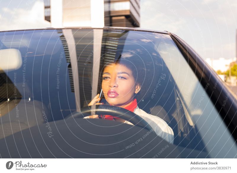 Serious black woman driving car and talking on smartphone driver call using speak conversation serious confident busy work female transport mobile thoughtful