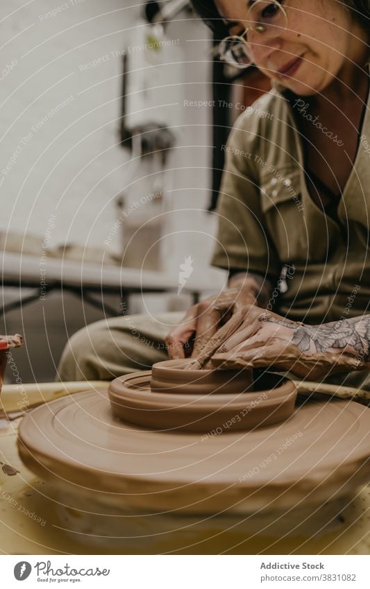 Crop ceramist making pot on clay wheel pottery workshop craftsman create maker handmade skill hobby occupation artisan handicraft tool small business ceramic