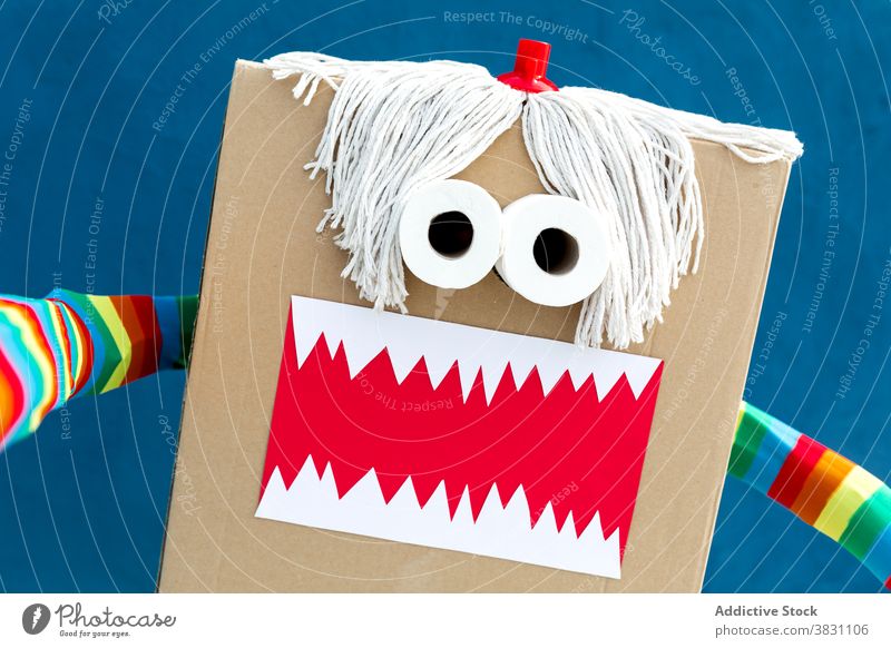 Child in funny carnival costume on street monster carton box child playful vivid handmade creative holiday party festive celebrate kid event fantasy masquerade