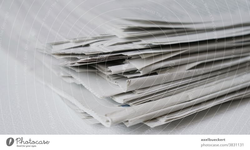 messy pile of newspapers or papers recycling print media heap stack information press journalism business publication current events concept recycle reading
