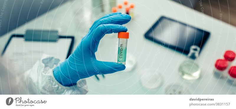 Scientist hand showing vial with vaccine scientist flask treatment coronavirus antidote cure investigation banner web header panorama panoramic