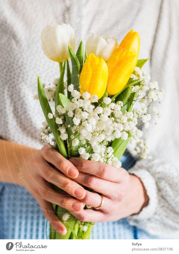 Woman holding bouquet of tulips. Woman's day woman background hands mother easter beautiful march bunch card festive floral flower gift give greeting valentine