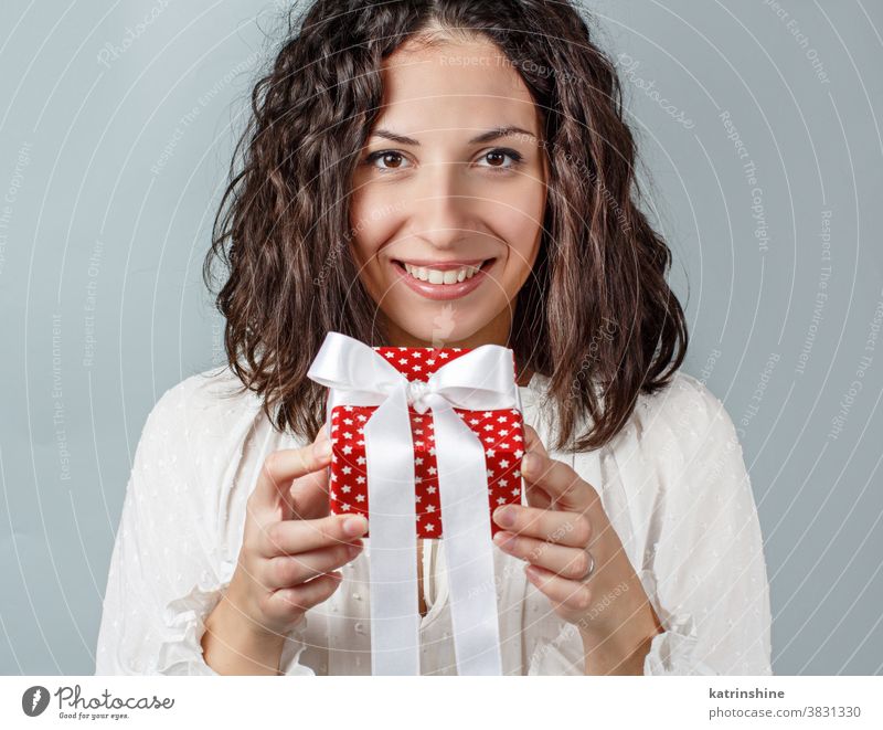 Young woman holding Gift package in hands close up Gift box christmas faceless white isolated red grey Wrapped Present casual Holiday Package Birthday handmade