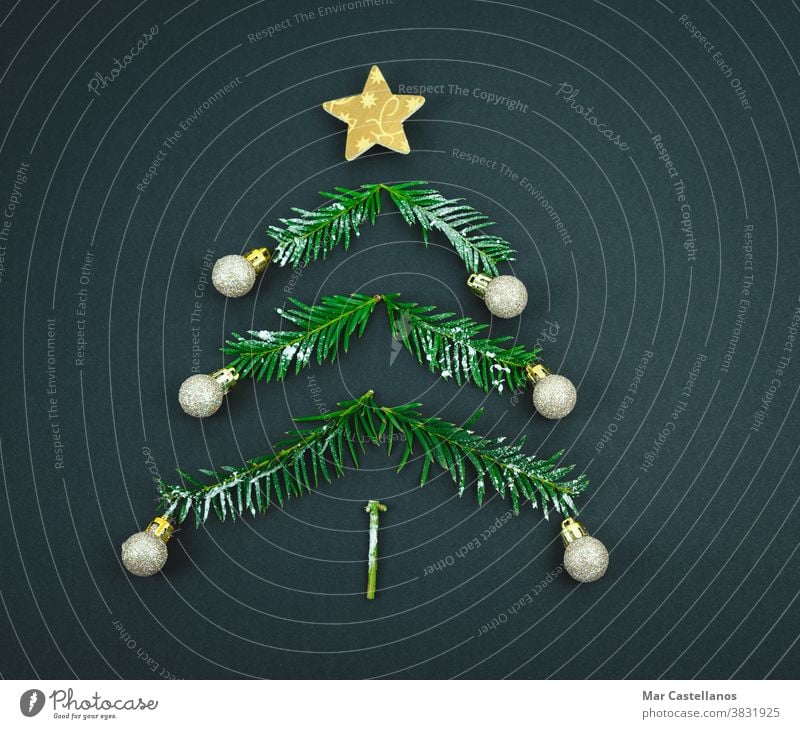 Christmas tree with star and balls made of pine branches on a black background. Copy space. decoration christmas end of the year space copy christmas tree