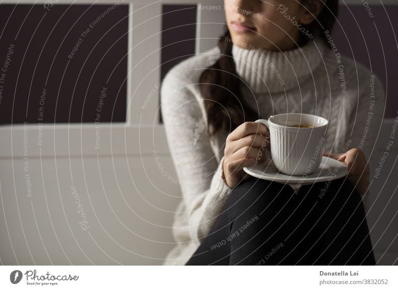 Girl holding a cup of tea adolescent bedroom beverage close up concept drink female from above fruit girl health healthy home indoor lifestyle liquid moment one