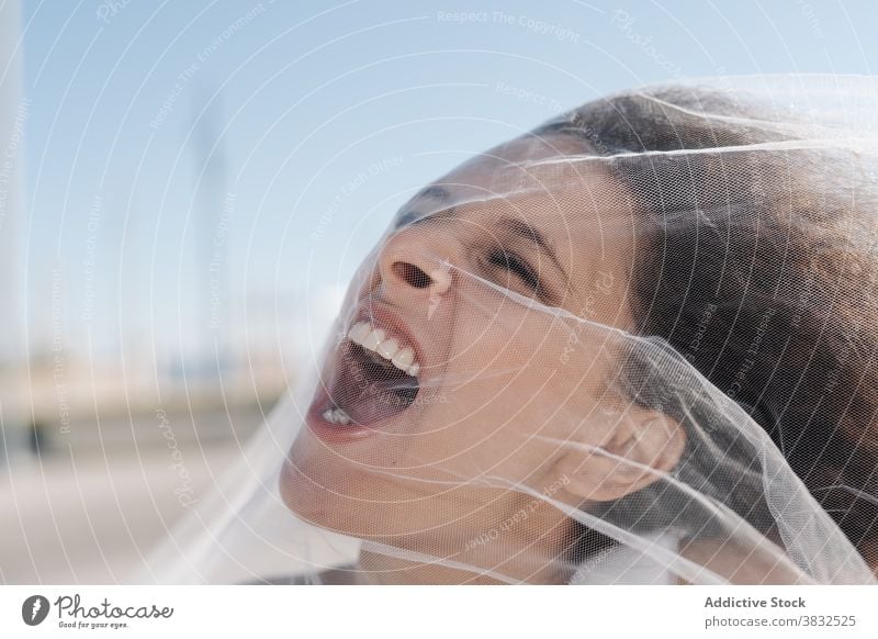 Aggressive annoyed woman in veil shouting bride anger aggressive bodacious angry curly hair scream depress transparent female sunny clear day fearless furious
