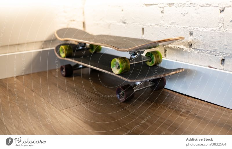 Skateboards placed in corner of room skateboard sport wheel equipment hobby extreme cool leisure ride object entertain balance simple apartment modern fun