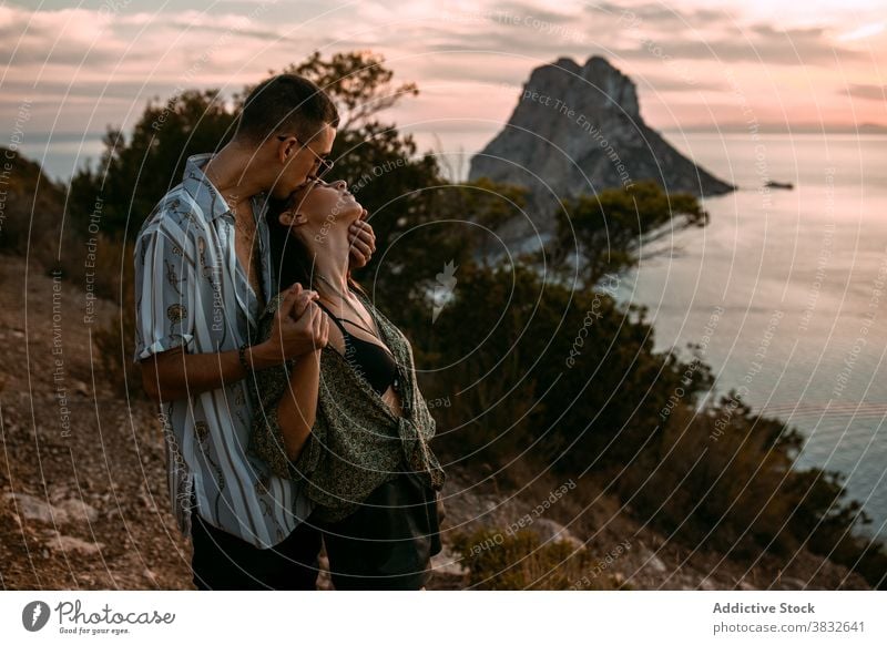 Couple in love kissing at sunset couple sea passion amorous cuddle hill relationship embrace romantic affection together hug boyfriend sky evening bonding