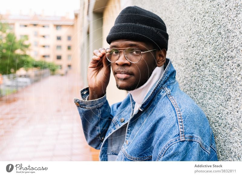 Stylish black man on street style eyeglasses put on denim outfit jacket trendy young male ethnic african american city modern confident town casual urban