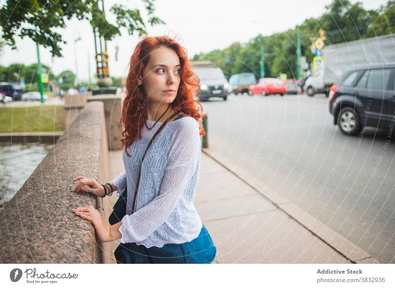 Redhead woman standing on urban bridge city red hair observe interest street road wait young redhead female millennial student lifestyle relax travel tourism