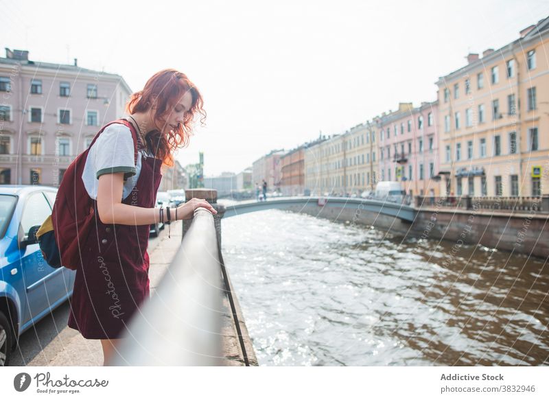 Female tourist standing near channel in city woman traveler urban rest sightseeing historic street water saint petersburg russia russian federation female young