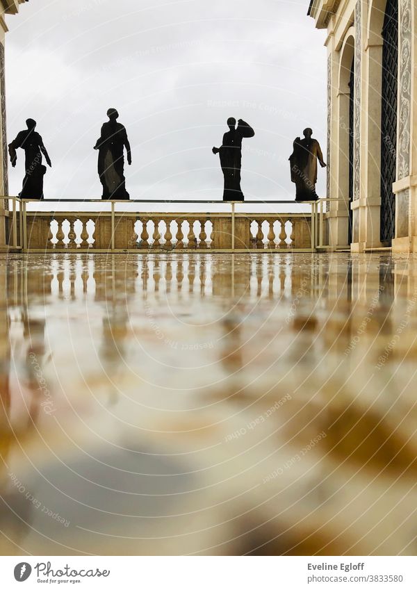 rainy terrace with silhouettes of roman women Rain Silhouette reflection parapet Architecture Wet balustrade Deserted Tourism