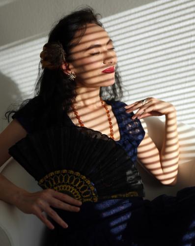 Sirinya Woman Dark-haired Long-haired Dress Colour Guide Sit sunbathe To enjoy sunny Shadow room Stripe Venetian blinds Jewellery Chain Closed eyes