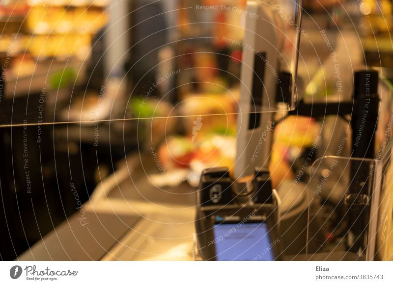 Plexiglas window and partition and card reader in the supermarket. Slice Supermarket Shopping corona Protection Partition Card payment contactless