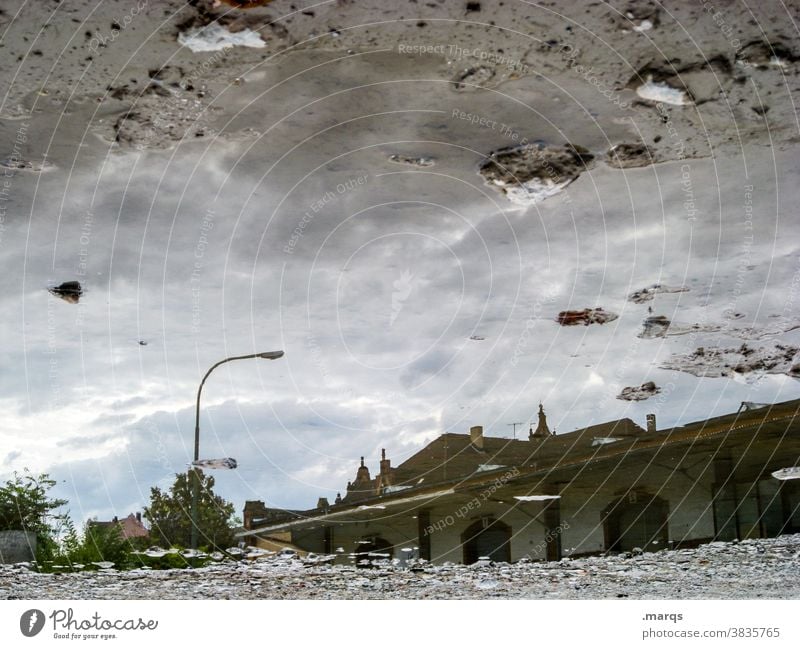 Goods station hall in a puddle Reflection Building Puddle Perspective Mirror image Sky Wet Water Deluge Gray Clouds Warehouse optical illusion