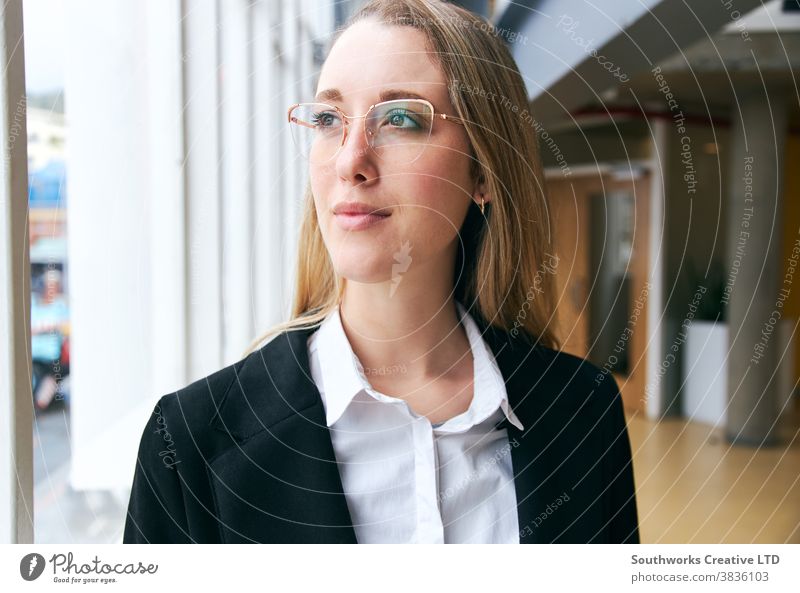 Portrait Of Young Businesswoman Wearing Glasses Standing In Modern Office During Health Pandemic business businesswoman working portrait office positive