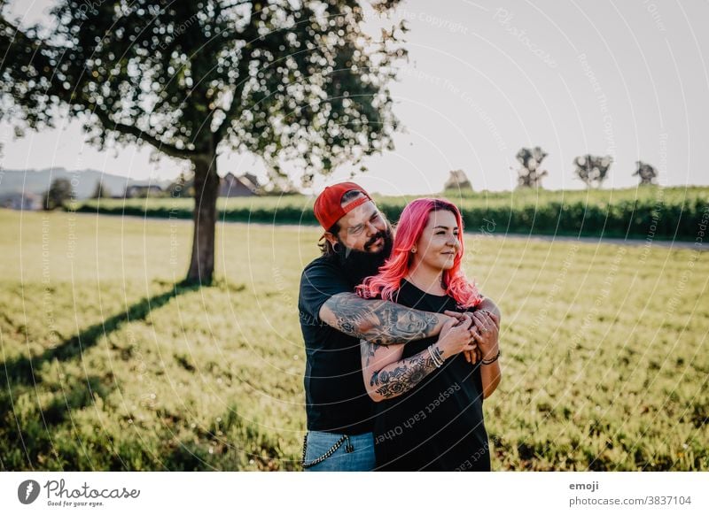 young couple with tattoos and pink hair teen Couple Love In love hug out Field Tattoo heartfelt Cuddling Hip & trendy Hipster Man Woman cheerful fortunate Happy
