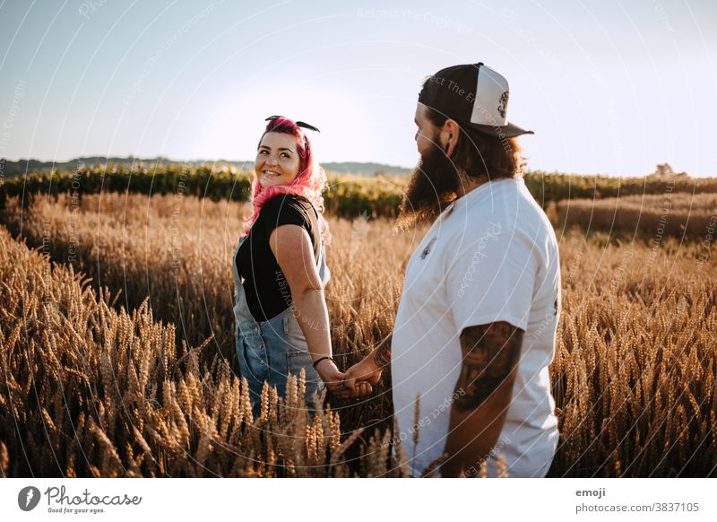 Couple with tattoos and pink hair in a cornfield Woman Man Hipster Hip & trendy Cuddling heartfelt Tattoo Cornfield Field out Love In love teen proximity